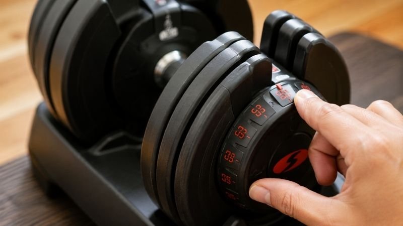 Close-up of adjustable dumbbell dial adjustment mechanism for home workout