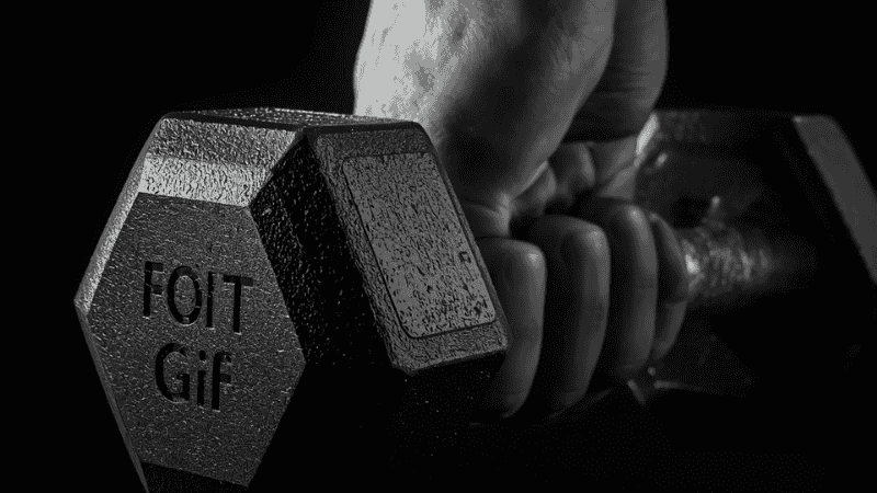 A close-up shot of the rubber hexagonal dumbbell-shaped metal handle with matte finish, showcasing the professional-level anti-slip texture that ensures a firm grip even when sweaty.